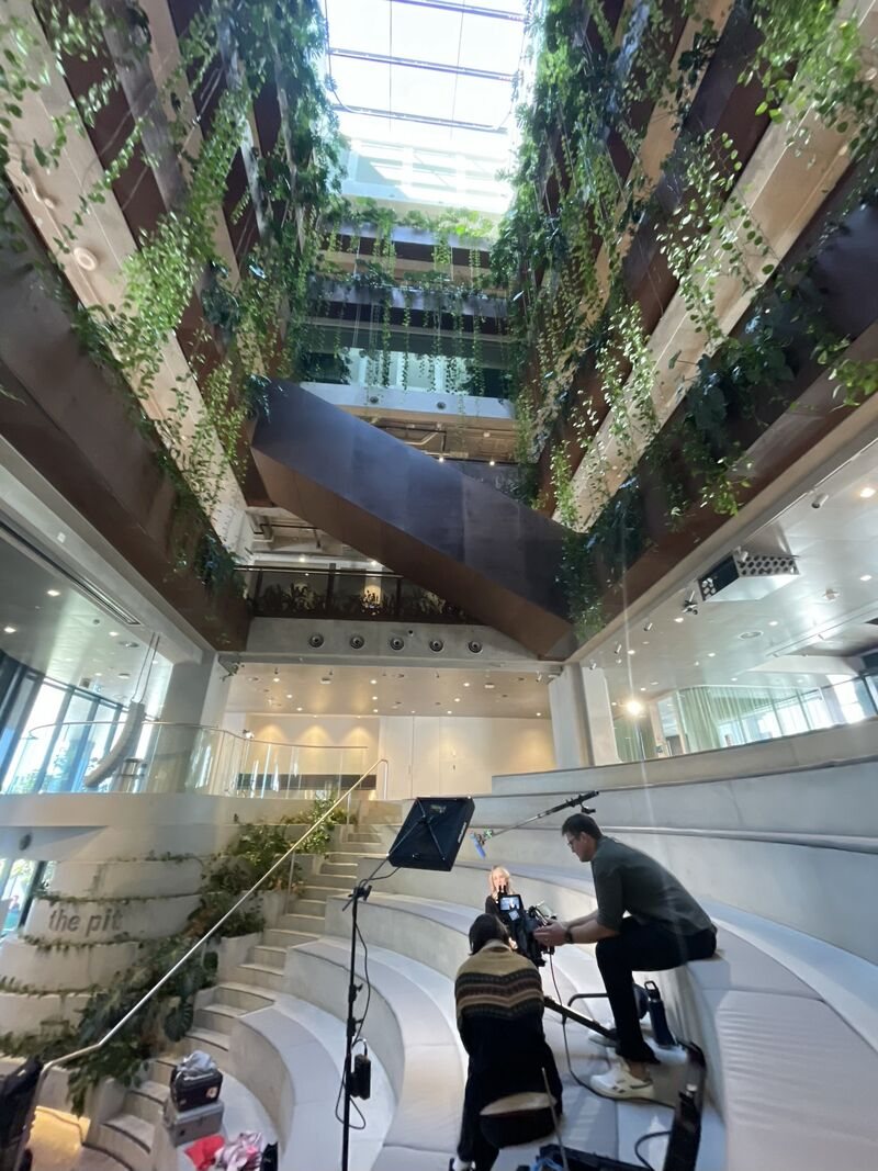 Camera crew setting up an interview in the atrium of a Brisbane corporate building