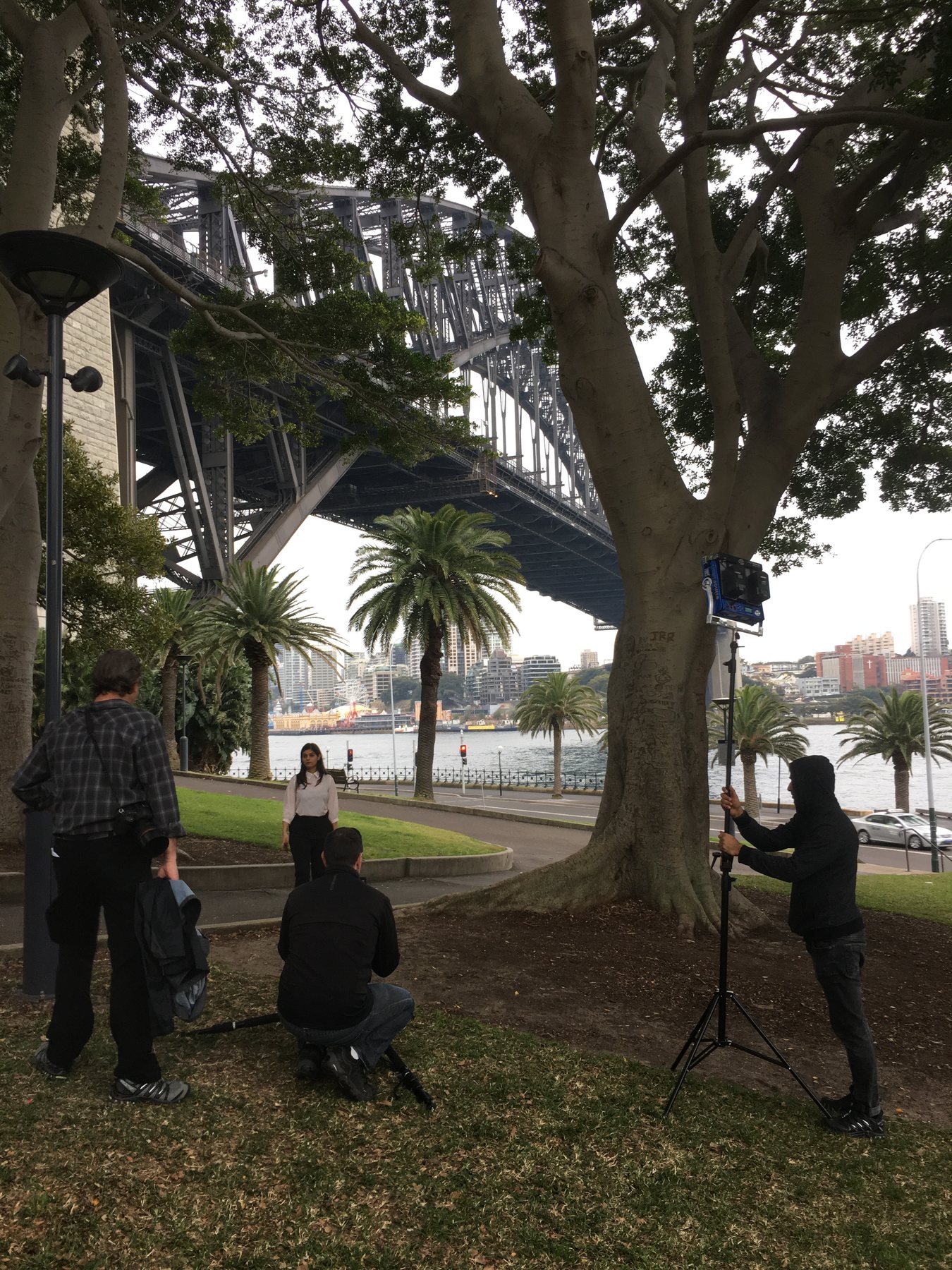 Camera crew filming a Workday employee near the Sydney Harbour Bridge