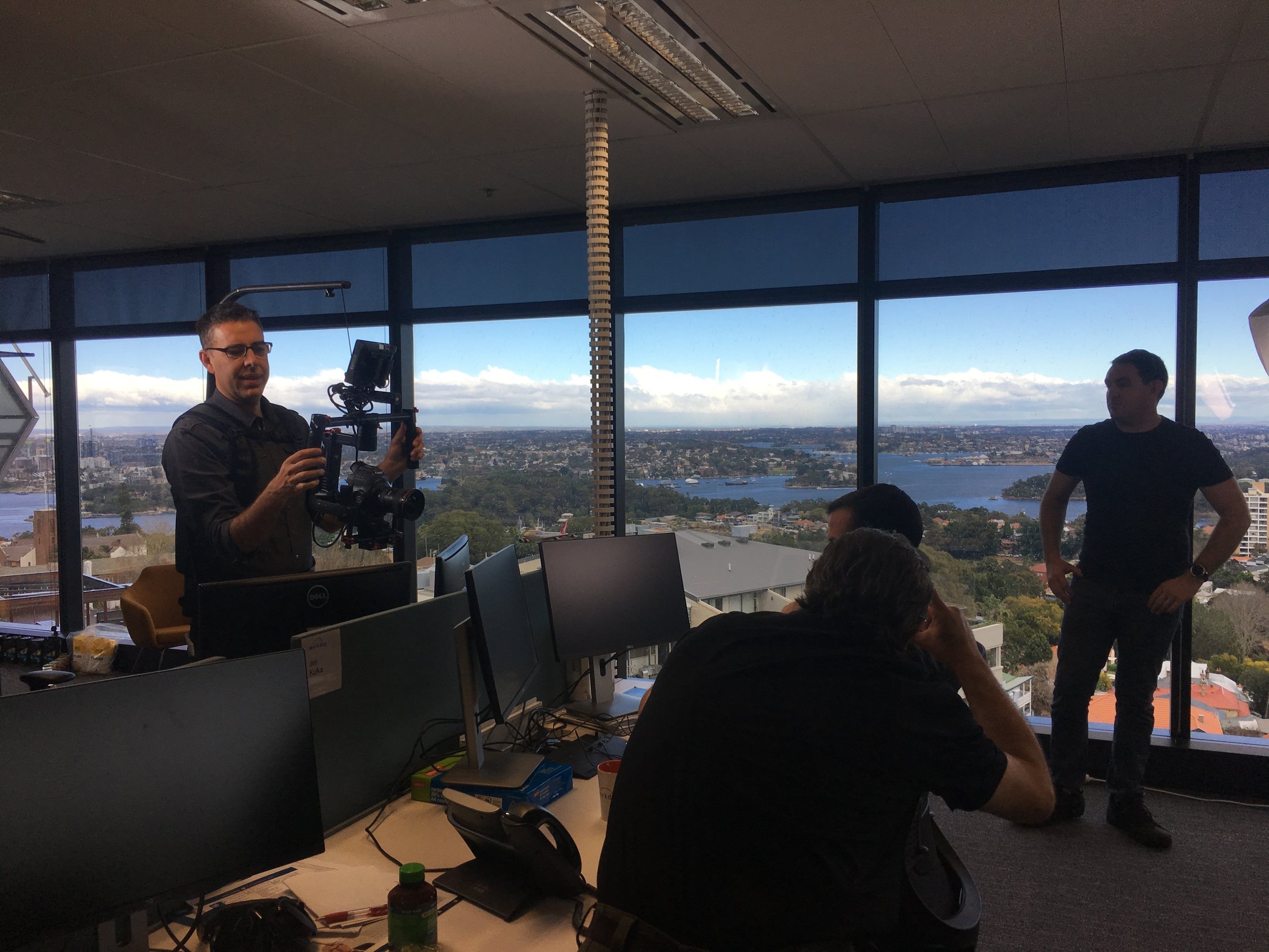 Camera operator preparing a gimbal inside Workday's North Sydney office