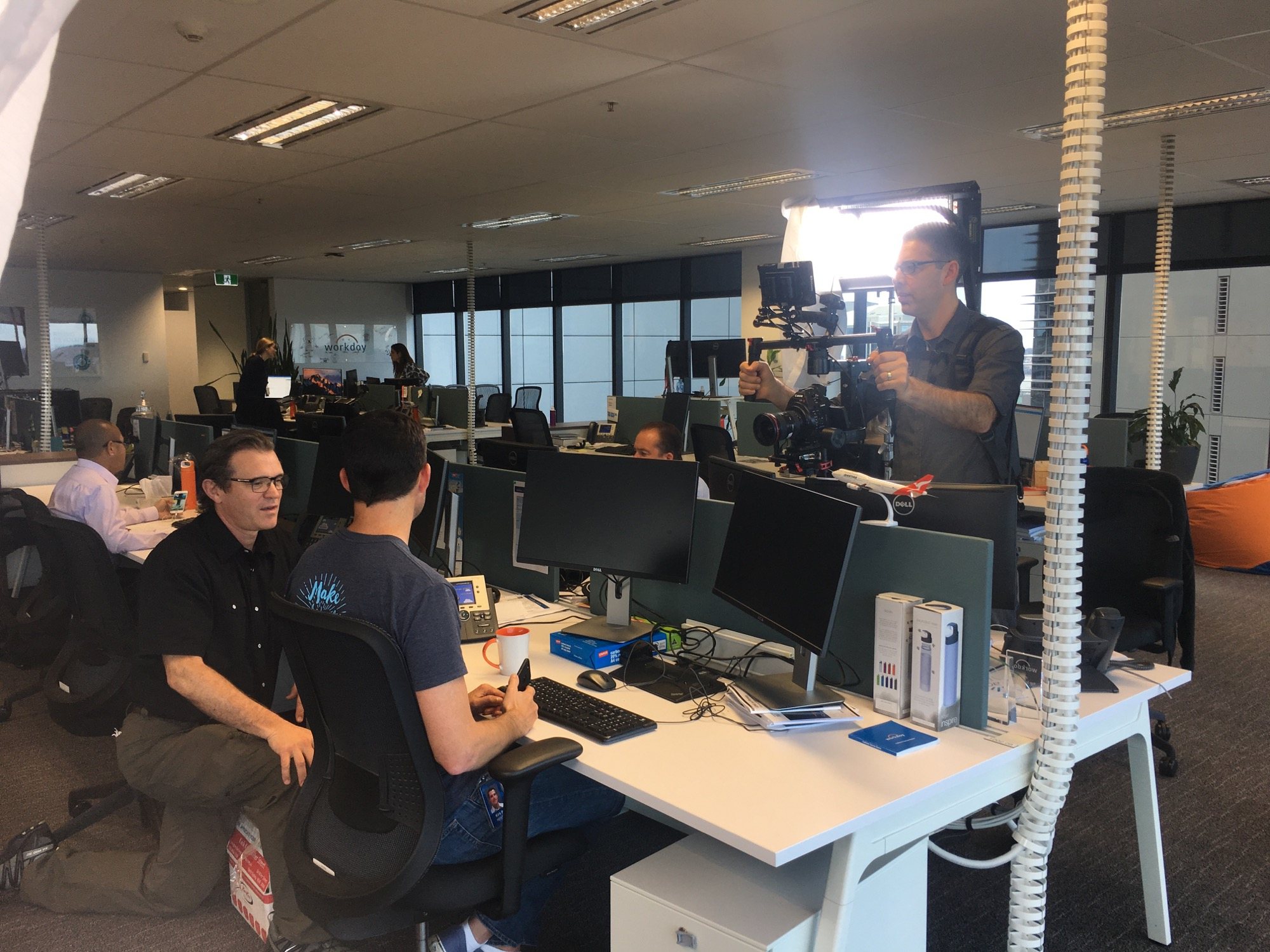 Camera crew filming workplace material inside Workday's Sydney office